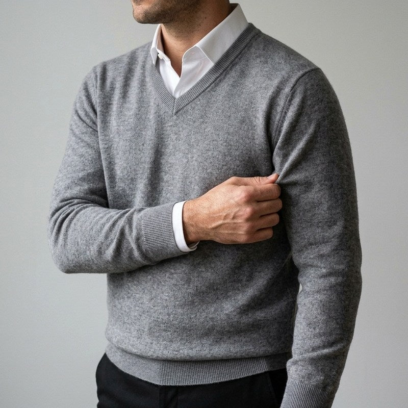 Close-up of a man pinching the fine knit of the sleeve of the Cashmere V-Neck Sweater in Grey